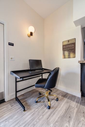 Computer and desk with chair for residents to work on personal business related items inside the clubhouse.at Fountains of Fair Oaks, California